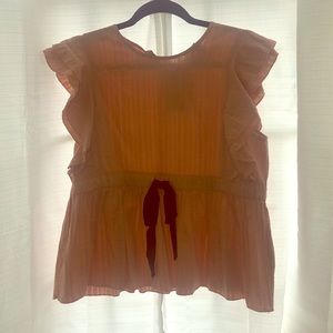 Peach blouse with ruffle details on the sleeves